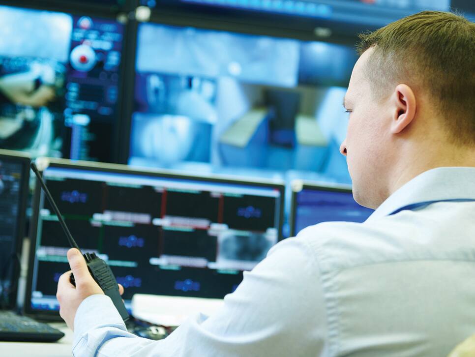 Man monitoring video surveillance footage