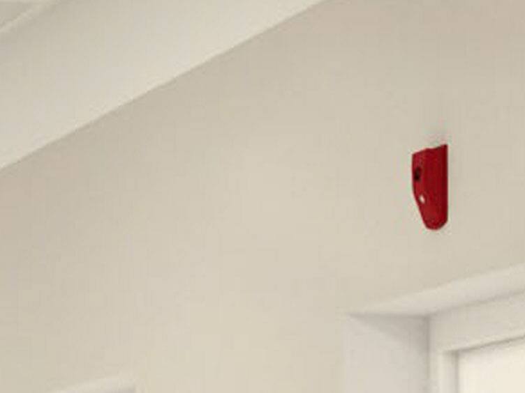 red fire alarm on ceiling