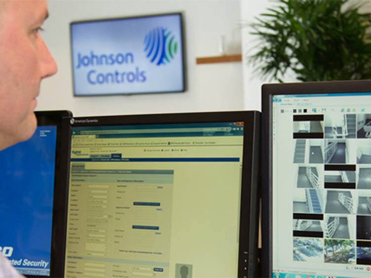 A security officer watching surveillance footage on a monitor