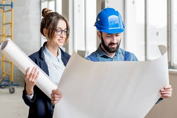 Construction workers viewing blueprints