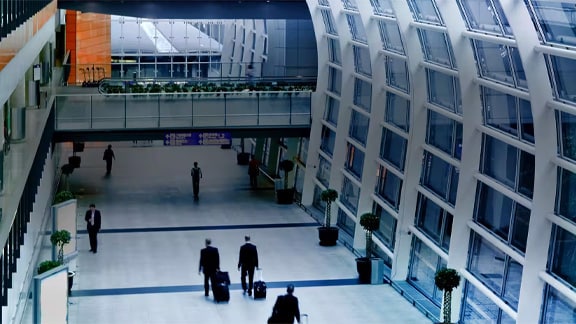 Interior motion picture of people walking in the Airport terminal