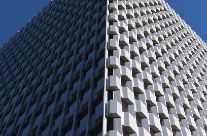 A white, modern building against the sky